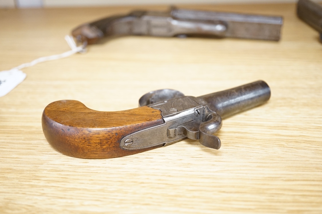 A boxlock percussion pocket pistol with turn off barrel, Birmingham proofs, trophy engraved frame, and slab walnut butt